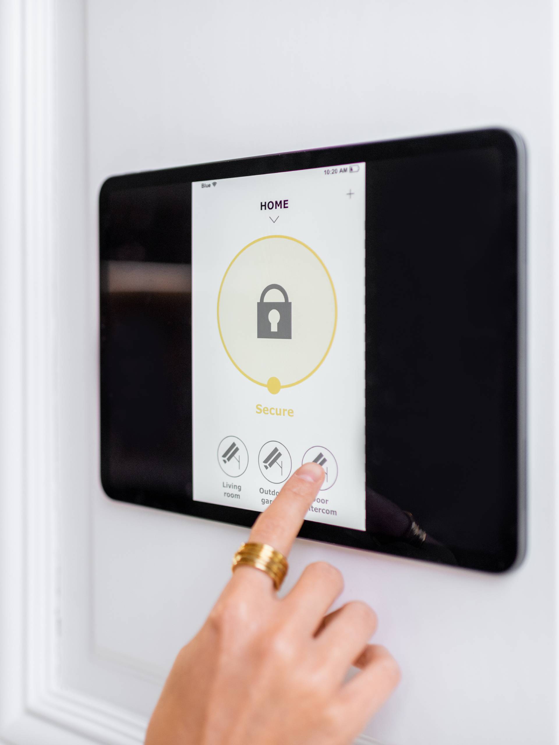 A homeowner using their smart home hub to control the entry locks with the smart lock feature open on the screen.